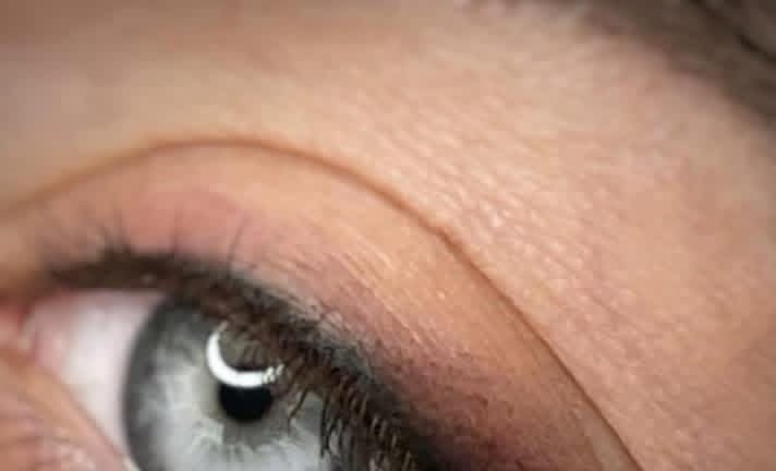 Fine permanent eyeliner defining the upper lash line